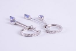 A pair of 9ct white gold drop earrings with a diamond set huggie type fitting and drops set with a