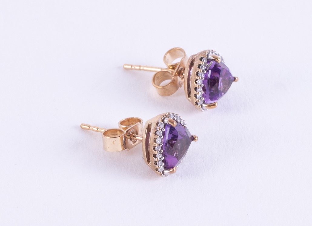 A pair of 9ct yellow gold stud earrings set with a triangular shaped amethyst and surrounded by tiny - Image 2 of 2