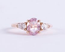 An 18ct rose gold ring set with a central oval cut pale pink sapphire, approx. 1.00 carat, with a