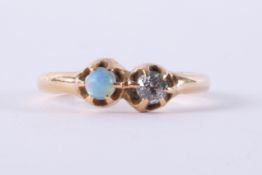 A yellow gold antique ring set with a cabochon cut opal measuring approx. 3.5mm and an old round cut