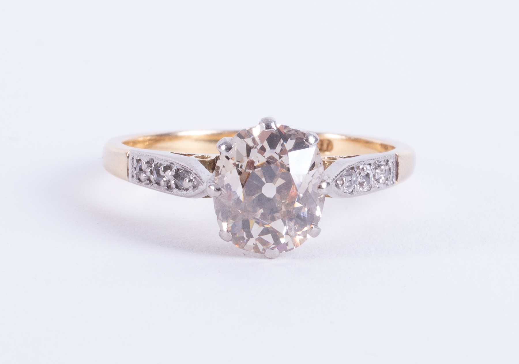 An antique 18ct yellow gold & platinum ring set with a central old oval cut diamond,