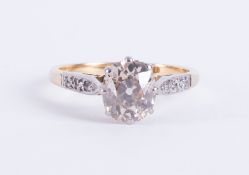 An antique 18ct yellow gold & platinum ring set with a central old oval cut diamond,