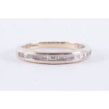An 18ct white gold half eternity style ring set with baguette cut diamonds (please note one of the