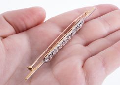 An antique 18ct yellow gold & platinum bar brooch set centrally with eight round old cut