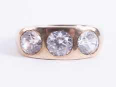 A heavy 18ct yellow gold ring set with three clear paste stones, 7.71gm, size T 1/2.