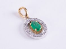 An 18ct yellow & white gold oval shaped pendant set with a central oval cut emerald, approx. 0.50