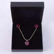 A set comprising of an 18ct yellow gold pendant set with an oval cut ruby, approx. 5.95 carats on an