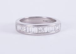 A heavy platinum half eternity ring set with a mixture of baguette cut & princess cut diamonds,