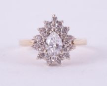 A 14ct yellow & white gold pear shaped cluster ring set with a central pear shaped diamond,