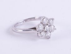 A platinum flower design ring set with round brilliant cut diamonds, total diamond weight 1.06