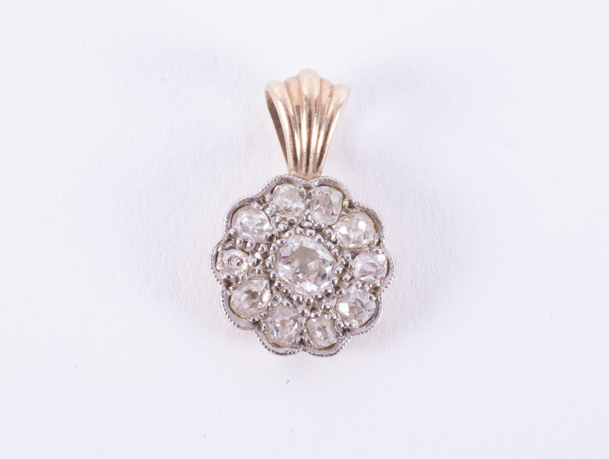 A 14k yellow & white gold flower design pendant set with old round cut diamonds, total diamond