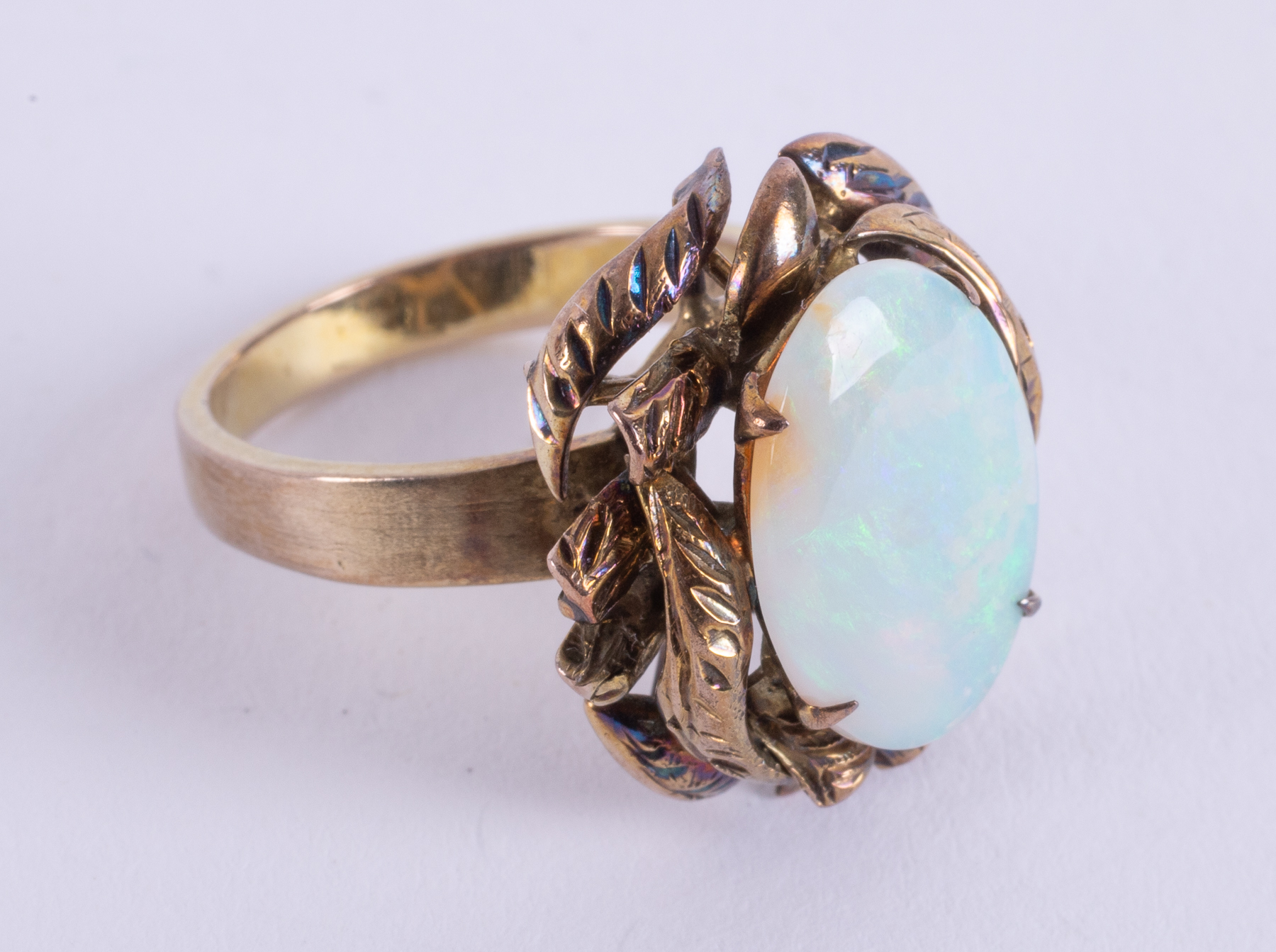 A 14k yellow gold ornately designed ring set with an oval cabochon cut opal, measuring approx. 14. - Image 2 of 2