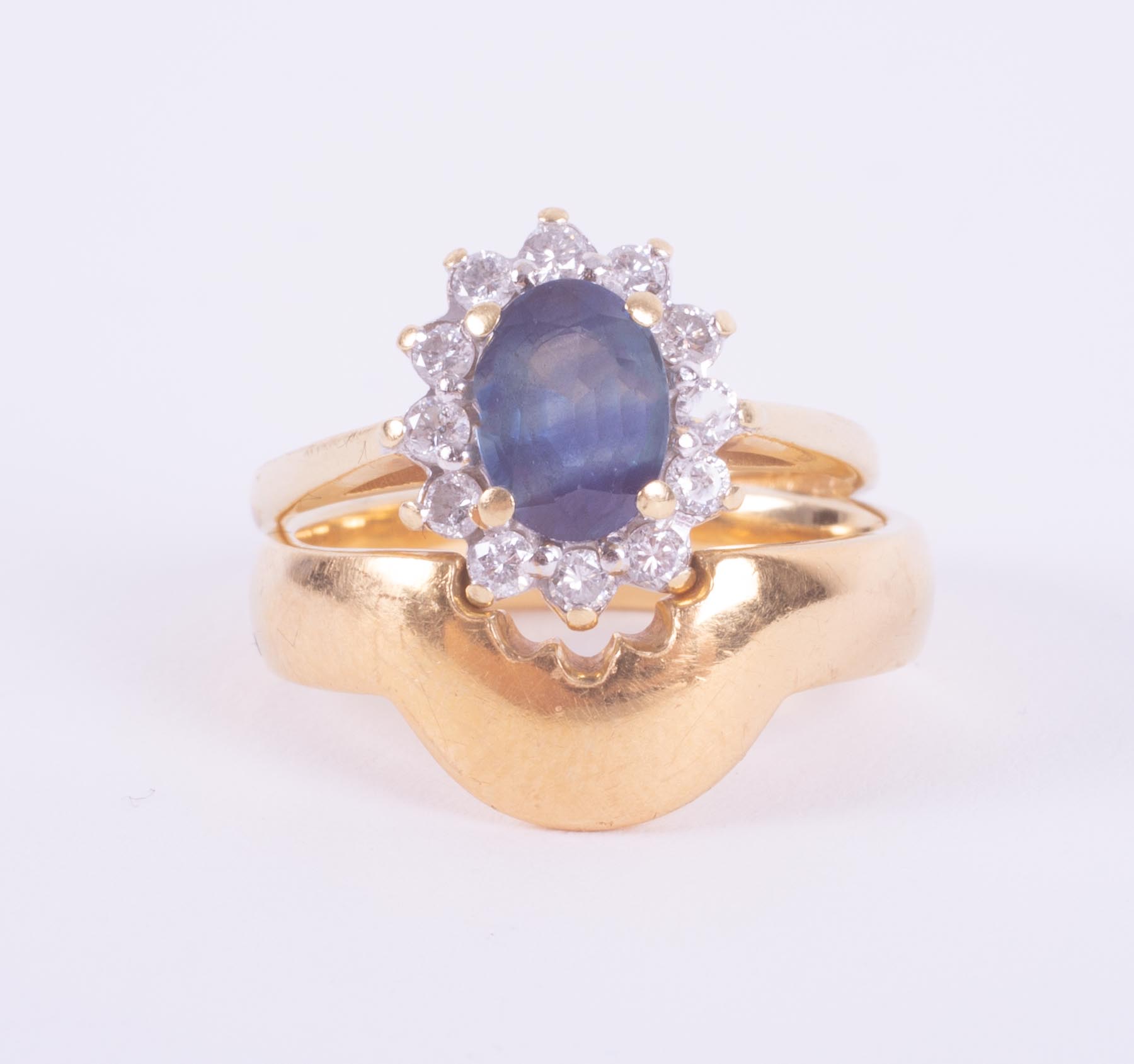 A set comprising of an 18ct yellow & white gold cluster design ring set with a central blue