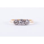 An 18ct yellow & white gold three stone ring set with three older round cut diamonds, total