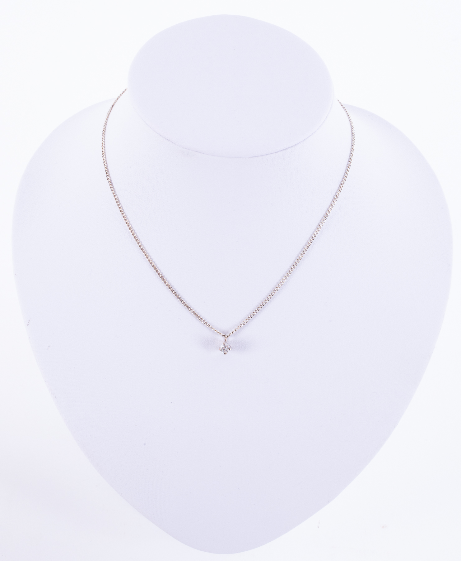 An 18ct white gold handmade pendant (not hallmarked or tested) set with a round brilliant