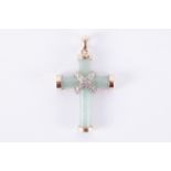 A 9ct yellow gold jade cross with a white gold central crossover design set round cut diamonds in an