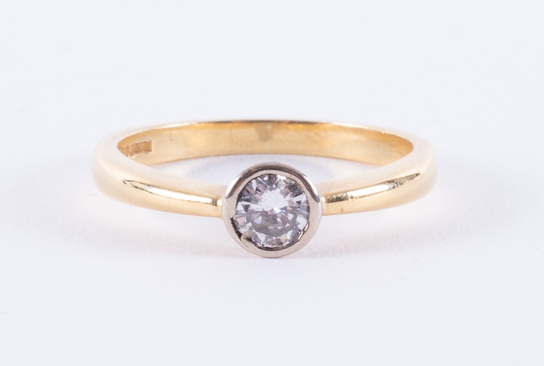 An 18ct yellow & white gold ring set with a round brilliant cut diamond, approx. 0.25 carats (the