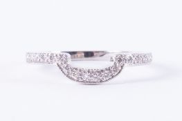 An 18ct white gold shaped band set half way around with small round brilliant cut diamonds,