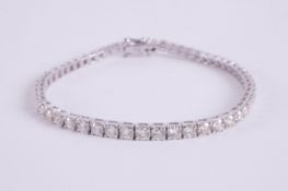 An 18ct white gold line bracelet set with approx. 6.00 carats of round brilliant cut diamonds,