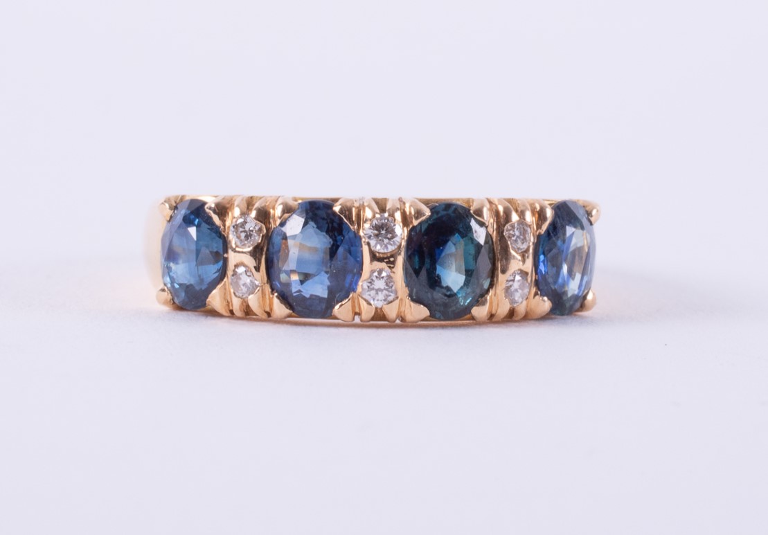 An 18ct yellow gold ring set with four oval cut sapphires, approx. total sapphire weight 1.40