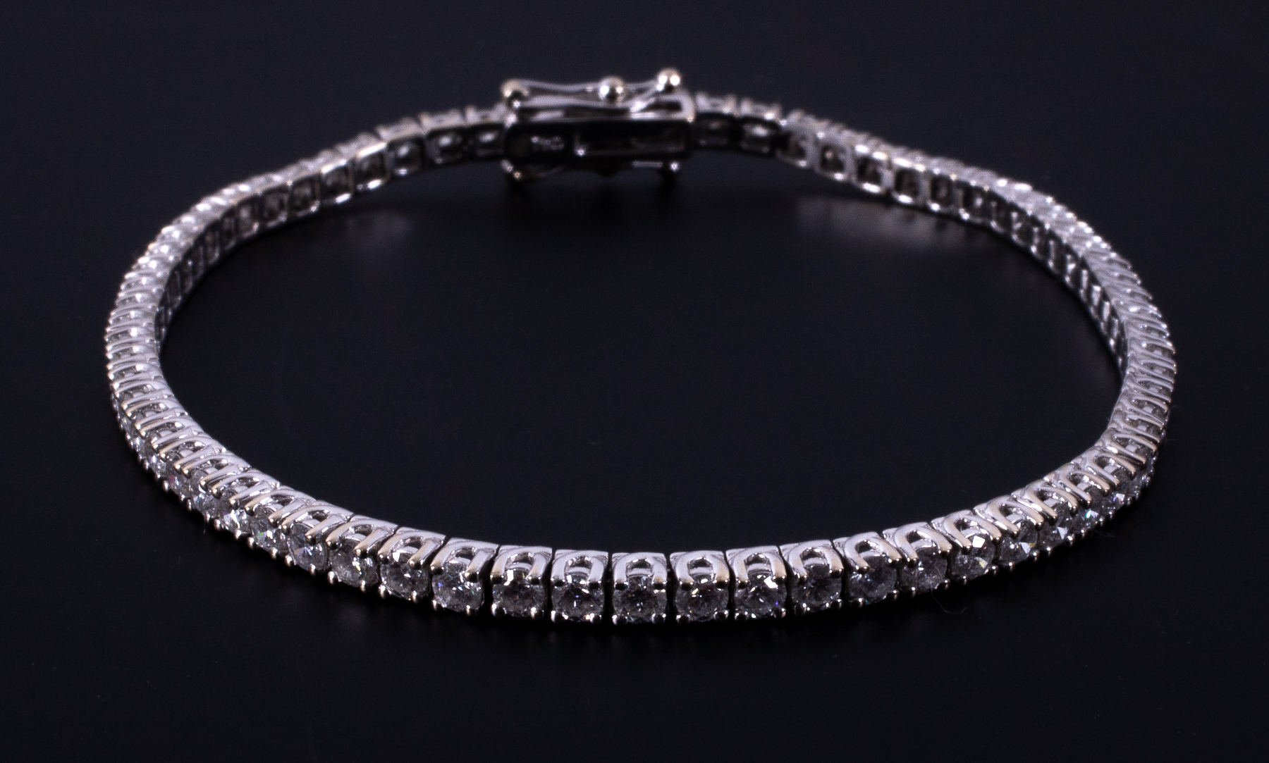 An 18ct white gold line bracelet set with approx. 3.50 carats of round brilliant cut - Image 2 of 2