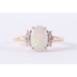 An 18ct yellow gold ring set with an oval cabochon cut opal, measuring approx. 10mm x 6.5mm x 2.2mm,