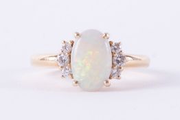 An 18ct yellow gold ring set with an oval cabochon cut opal, measuring approx. 10mm x 6.5mm x 2.2mm,