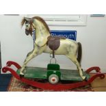 A Haddon & Sons rocking horse, dapple grey, with combination rocker and wheels, overall height
