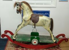 A Haddon & Sons rocking horse, dapple grey, with combination rocker and wheels, overall height
