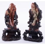 A pair of carved Oriental soapstone figures on carved wood base, 26cm.