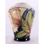 A Moorcroft small vase decorated with flowers, dated 05, signed Kerri, height 11cm.