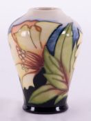 A Moorcroft small vase decorated with flowers, dated 05, signed Kerri, height 11cm.