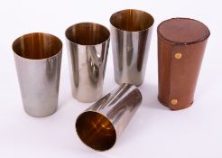 A Military leather cased campaign set of five gilt lined metal beakers.