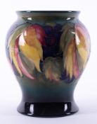 A William Moorcroft vase decorated with leaf and berries, 17cm height.