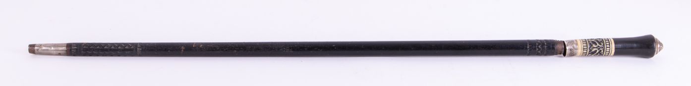 An ebonised and carved bone sword stick, length 93cm.