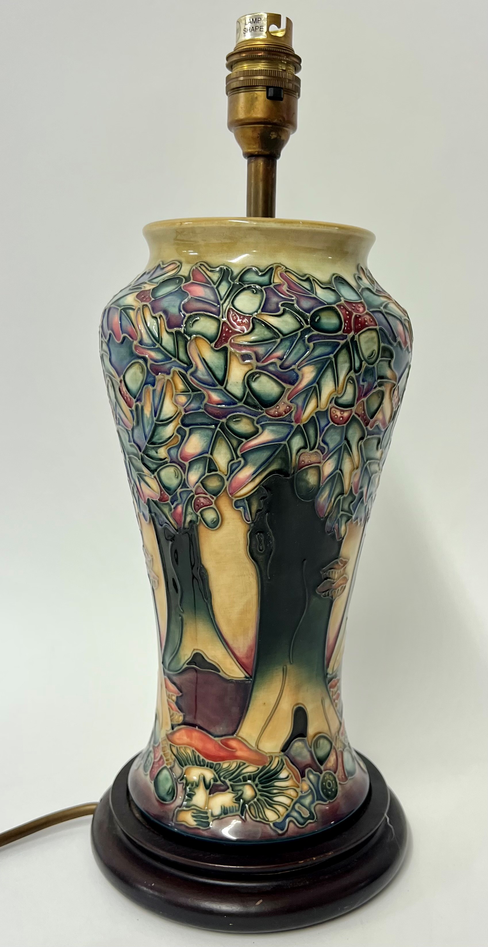 A Moorcroft lamp decorated with trees and mountains, height 38cm including stand.