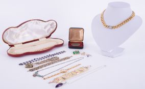A mixed lot of costume jewellery to include bracelets, necklaces, watch, brooch, pin badge, silver