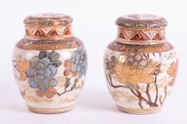 Japanese, a pair of earthenware jars with covers, height 14cm, (faults).
