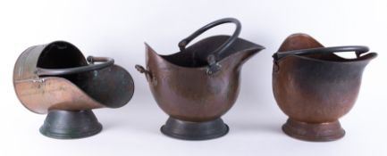 Three Victorian copper helmet coal scuttles.