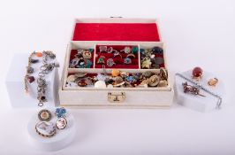 A mixed collection of costume jewellery to include brooches, badges, earrings, rings etc.