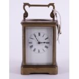 A French brass cased carriage clock with key, height including handle 18cm.