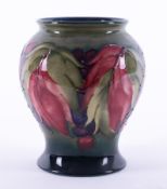 A William Moorcroft vase decorated with leaf and berries, height 14cm.