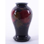 A William Moorcroft miniature baluster vase decorated with Pomegranate.