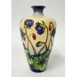 A Moorcroft vase, decorated with purple flowers, height 16cm.