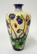 A Moorcroft vase, decorated with purple flowers, height 16cm.
