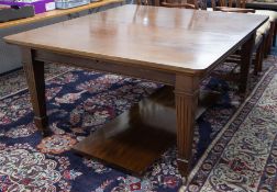 A heavy early 20th century mahogany dining table with extension leaf, on square taper