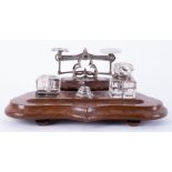 A desk set containing inkwell (one no lid) and weights on stand.