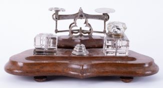 A desk set containing inkwell (one no lid) and weights on stand.