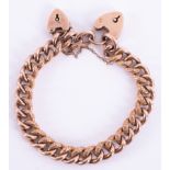 A 9ct rose gold curb bracelet with heart padlock and an extra 9ct rose gold heart padlock, 17.24gm.