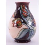 A Moorcroft vase, decorated with flowers, height 20cm.
